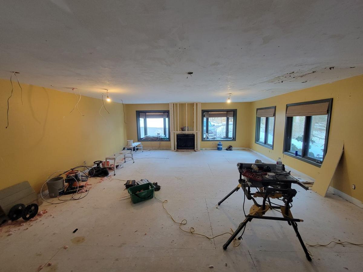 Family room before: stripped walls, subfloor and tools
