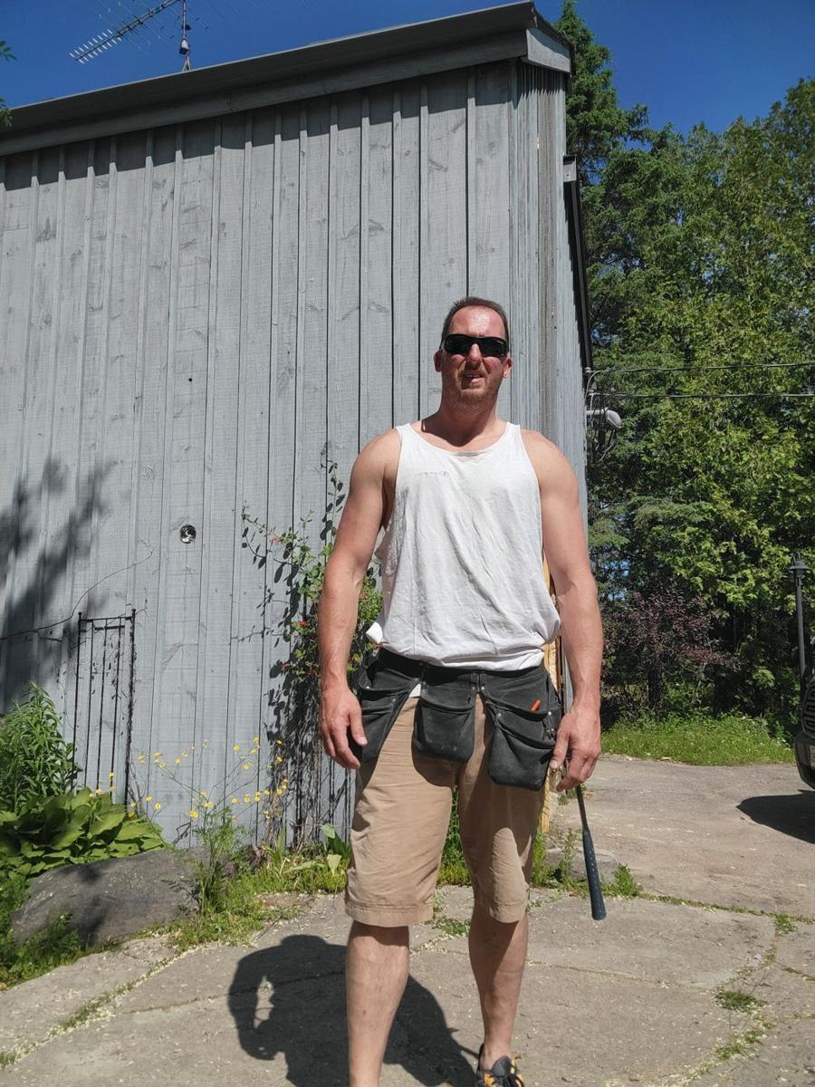 Mark Kajin, founder of Contractor 4 Life, wearing a tool belt on a job site